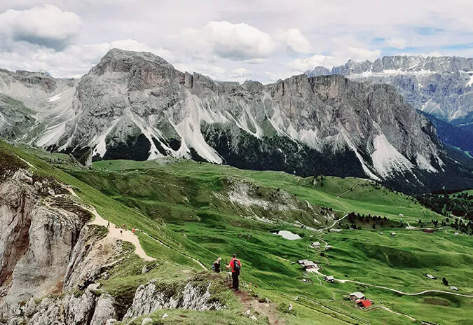 Green alpine pastures beneath the Dolomites