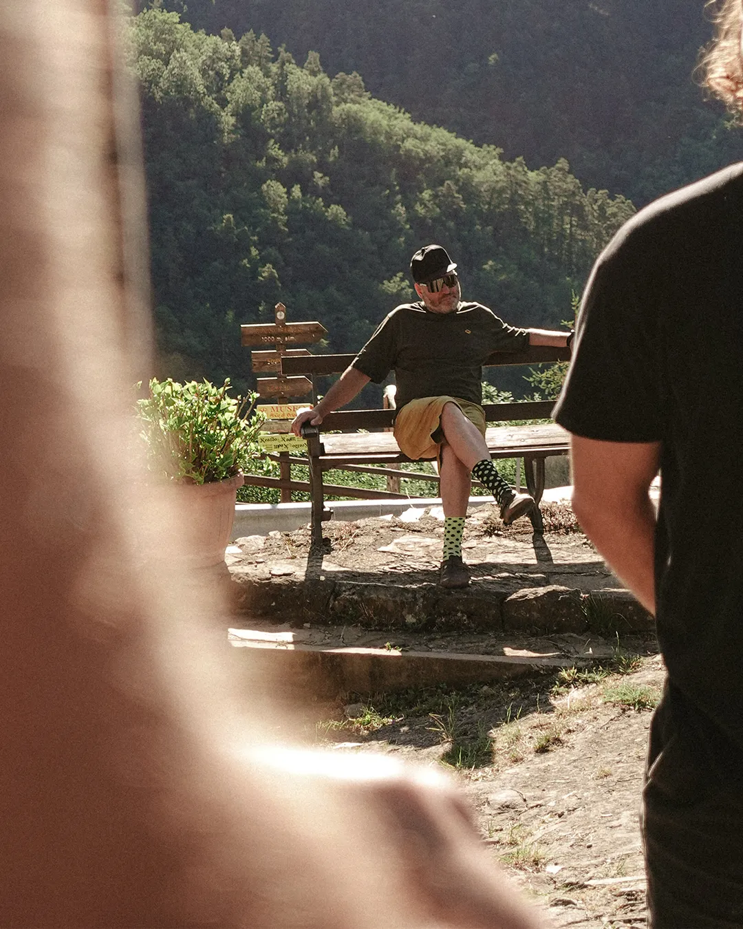 Rider resting on a bench in a village