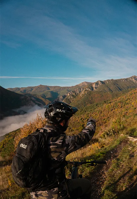 Rider looking over a sea of clouds in the mountains above Nava